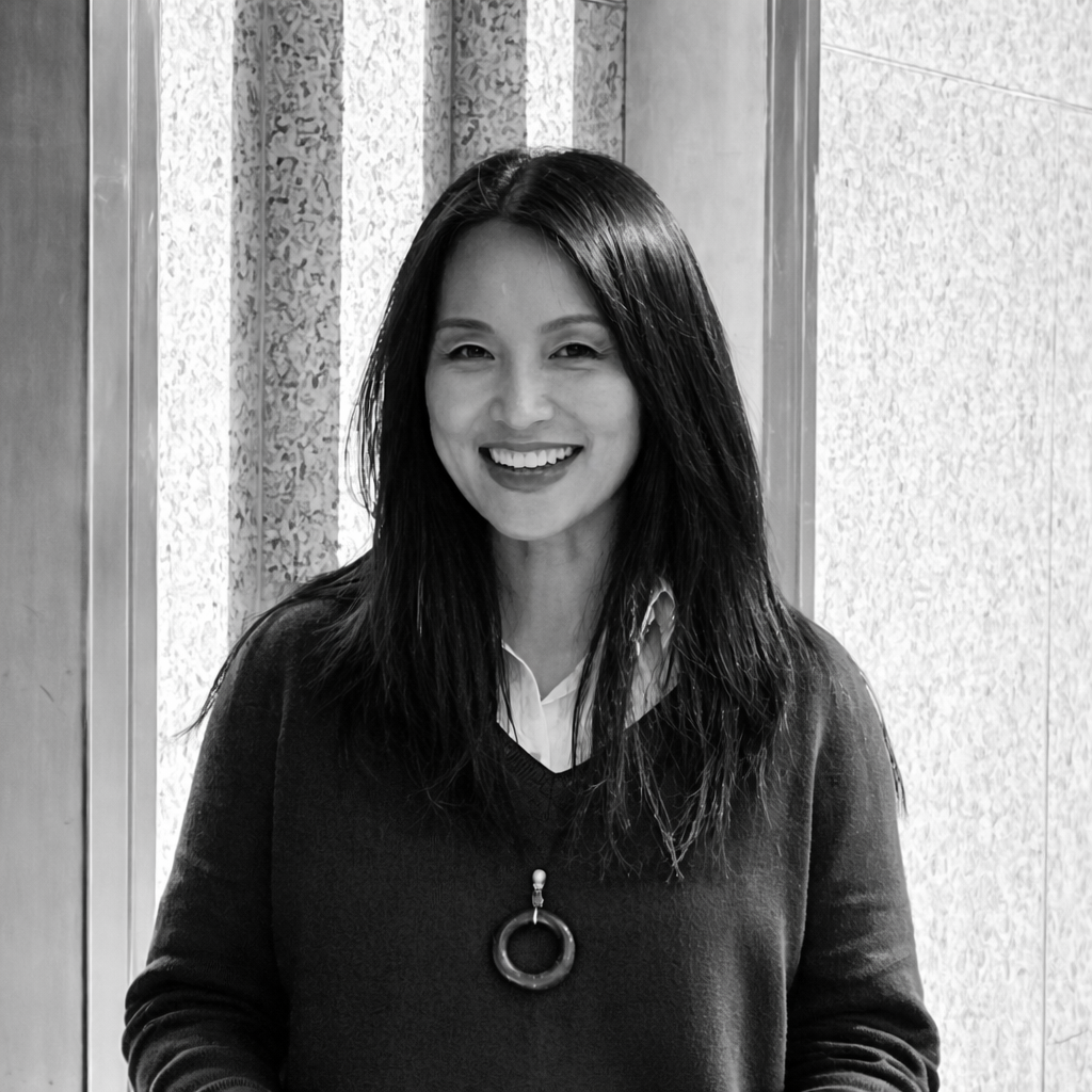 Portrait of Kehan Li, independent high jewellery adviser and valuer, wearing a circular jade pendant.